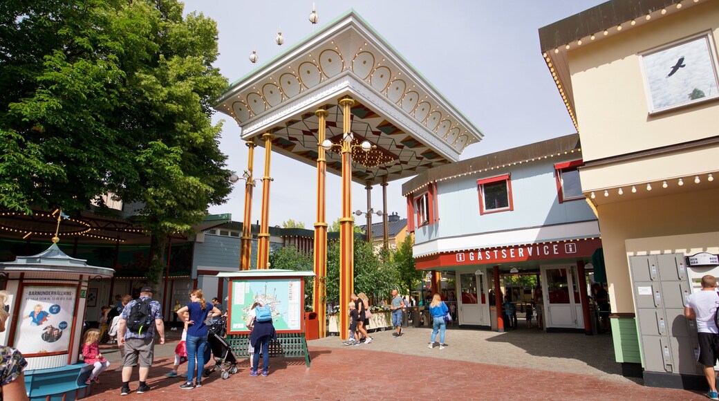 Tivoli Grona Lund showing rides as well as a small group of people