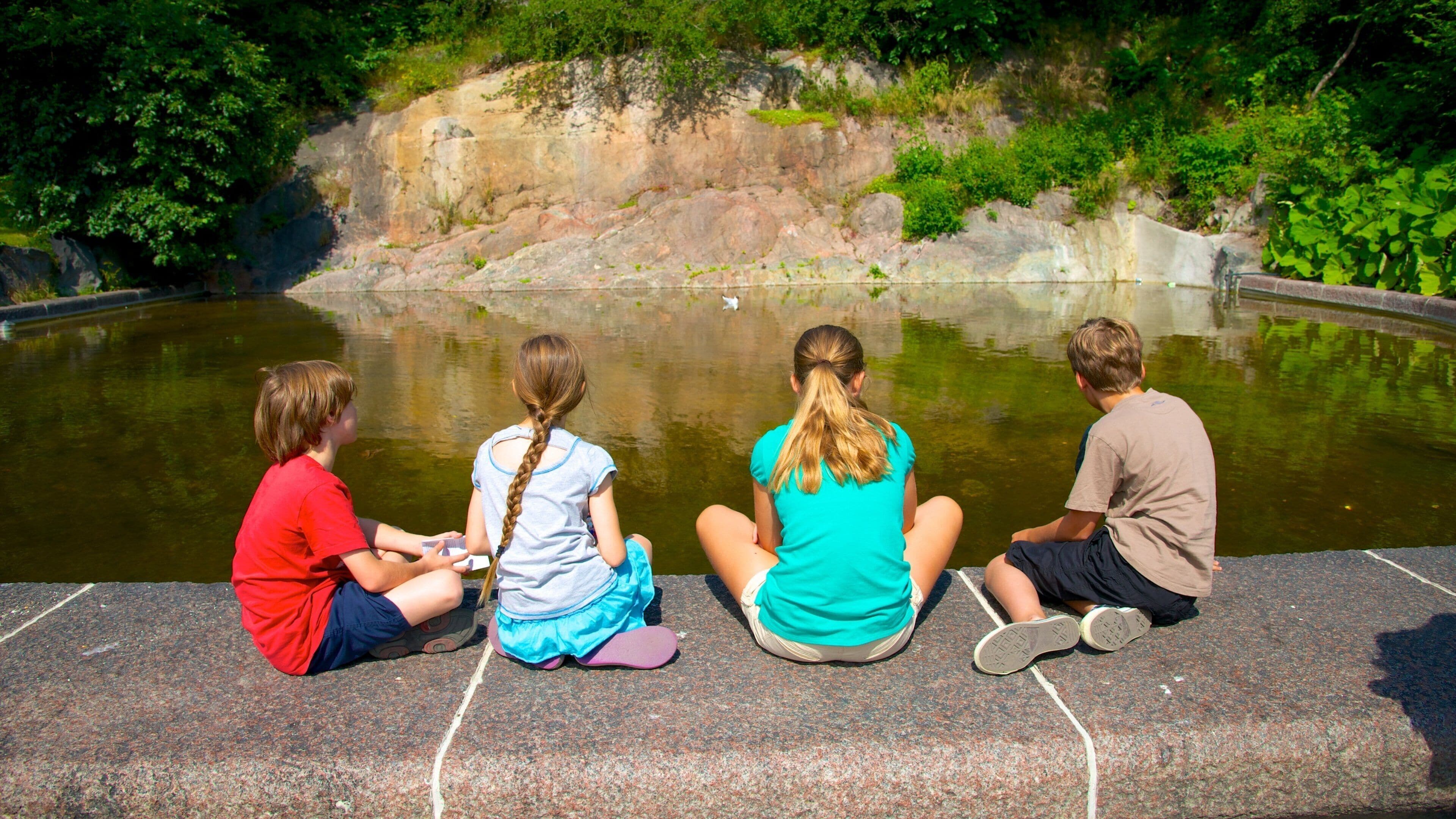 Stockholm showing a pond as well as children