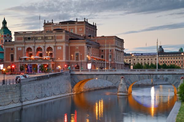 Royal Swedish Opera featuring a bridge, a river or creek and a sunset