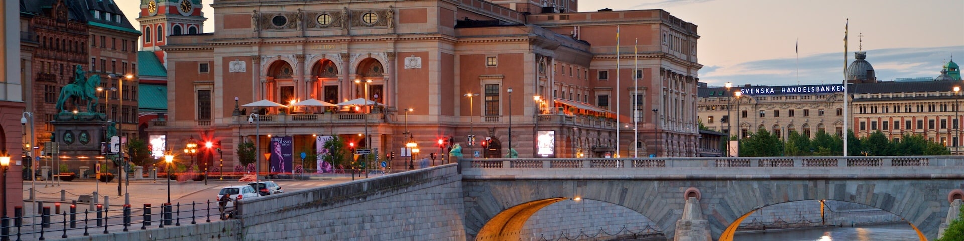 Royal Swedish Opera featuring a bridge, a river or creek and a sunset