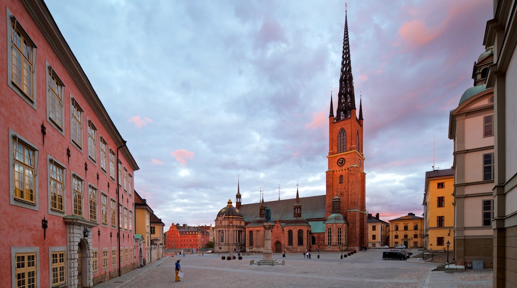 Riddarholmen Church showing a square or plaza, a sunset and a city