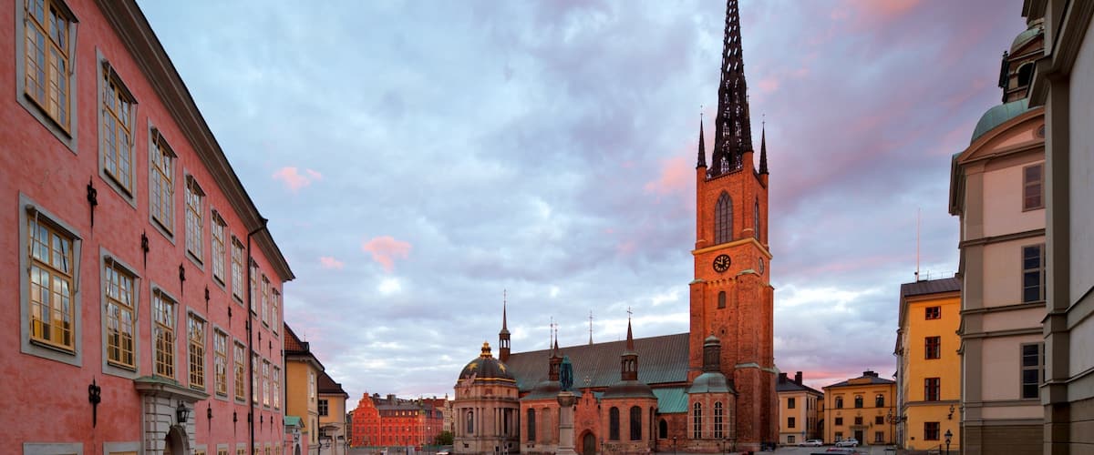 Riddarholmen Church showing a square or plaza, a sunset and a city