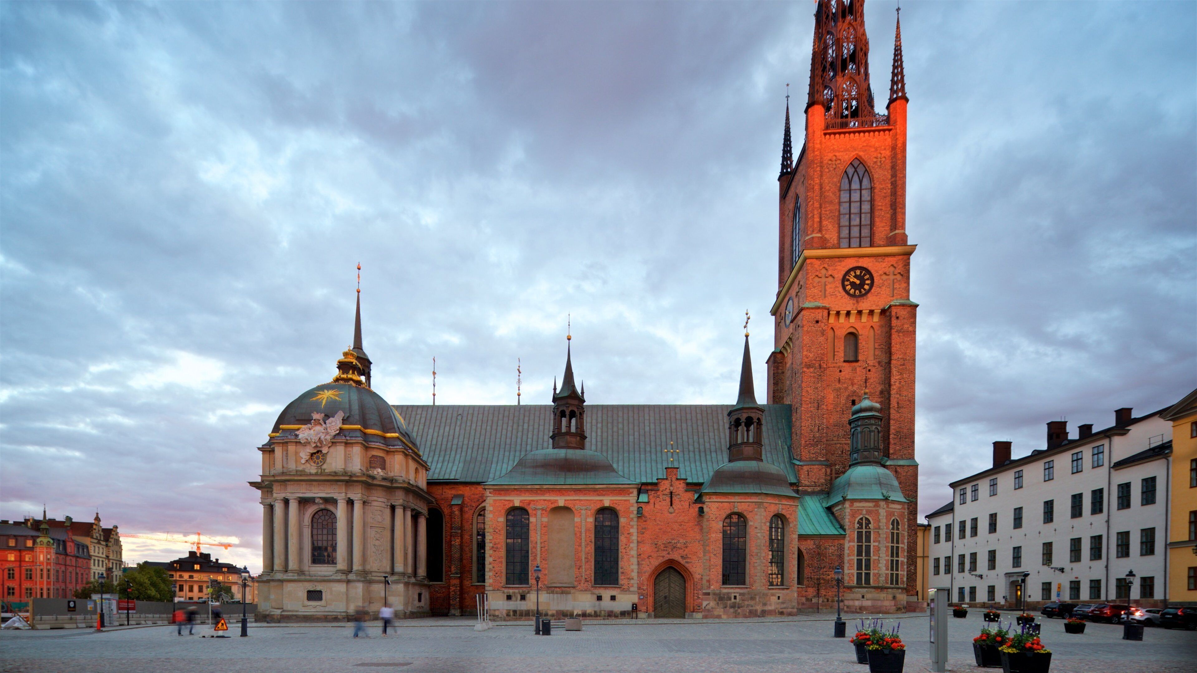 Riddarholmen Church showing heritage architecture, a sunset and a city