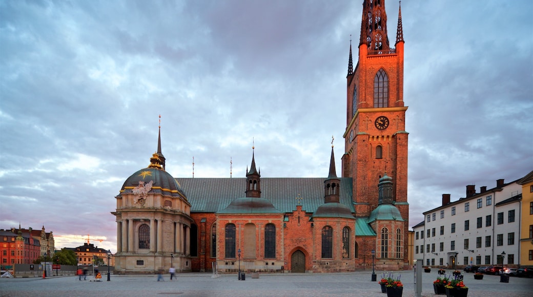 Riddarholmen Church showing heritage architecture, a sunset and a city