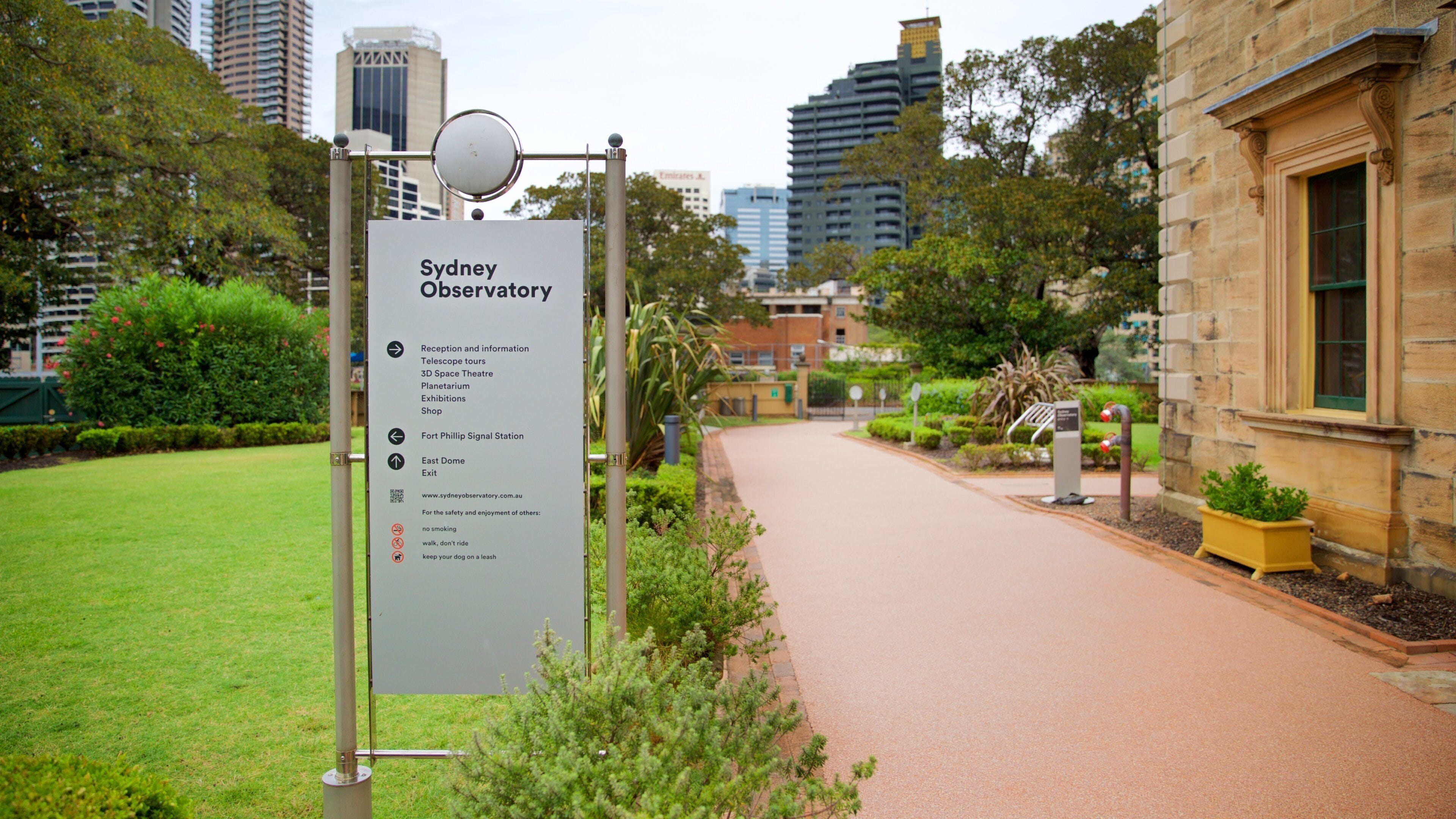 Sydney Observatory featuring a park and signage