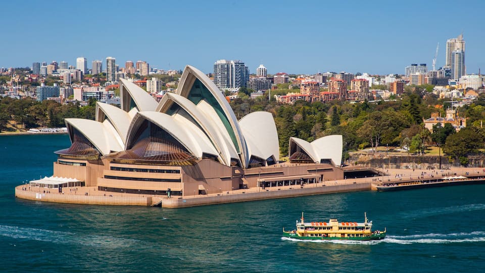 Sydney Opera House showing a monument, modern architecture and a city
