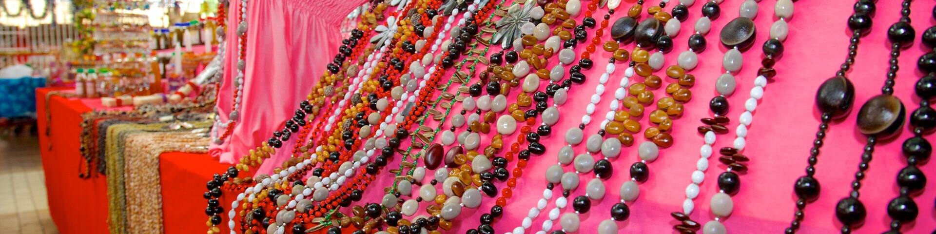 A variety of colorful necklaces displayed on a table in a market.