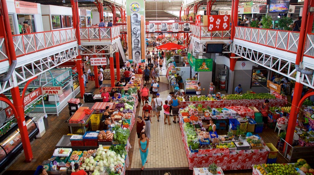 Papeete Market featuring interior views and markets as well as a small group of people