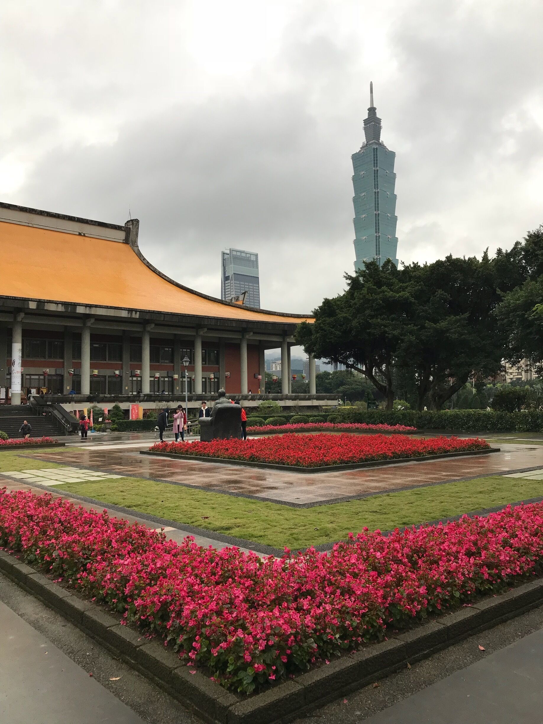 National Memorial in Taipei and the Taipei 101 tower in the background.