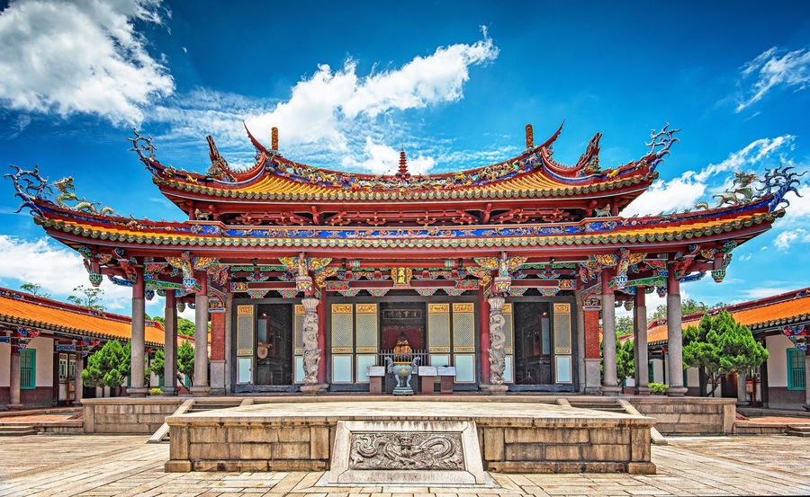 A traditional Chinese temple with ornate architecture, including a multi-tiered roof and colorful decorations.