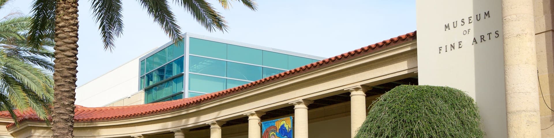 A museum with columns, a banner, and a staircase.