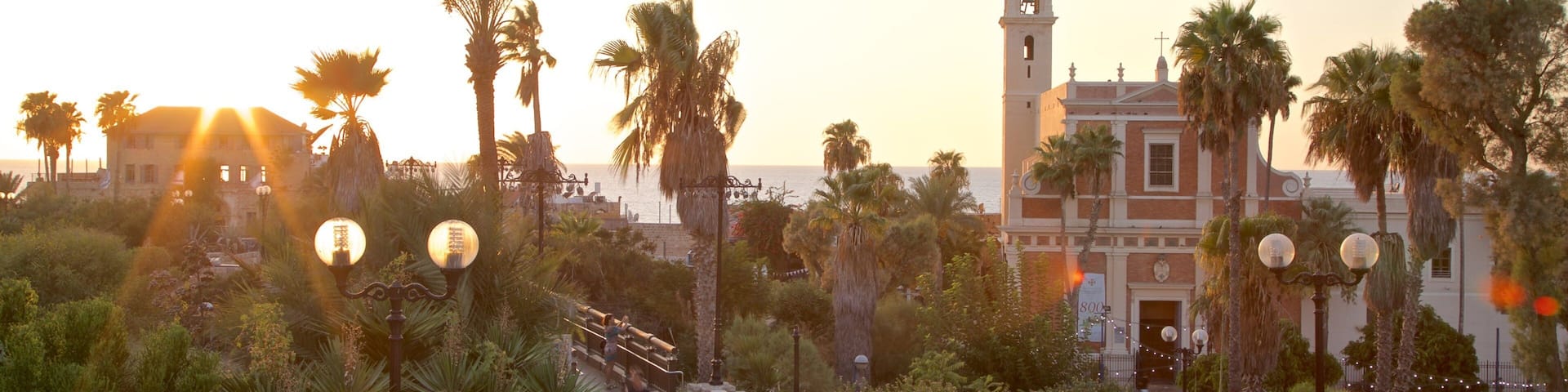 Church of St. Peter featuring a sunset, a church or cathedral and a garden