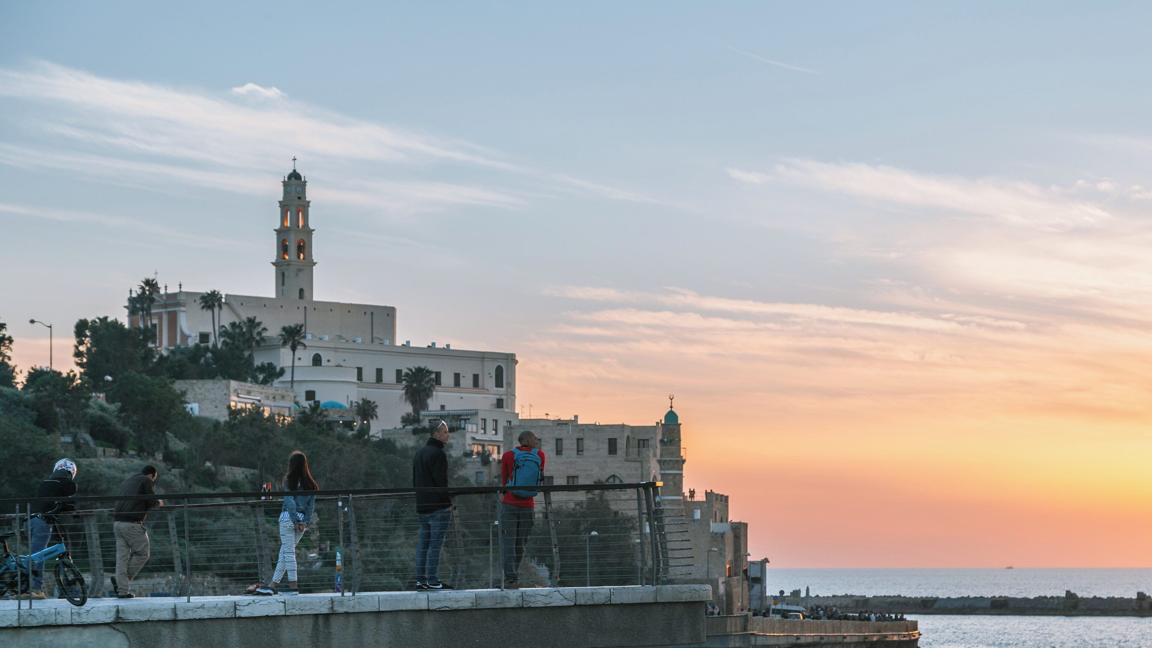 Sunset overlooking St. Peter's Church in Jaffa, Tel Aviv, Israel with visitors enjoying the view