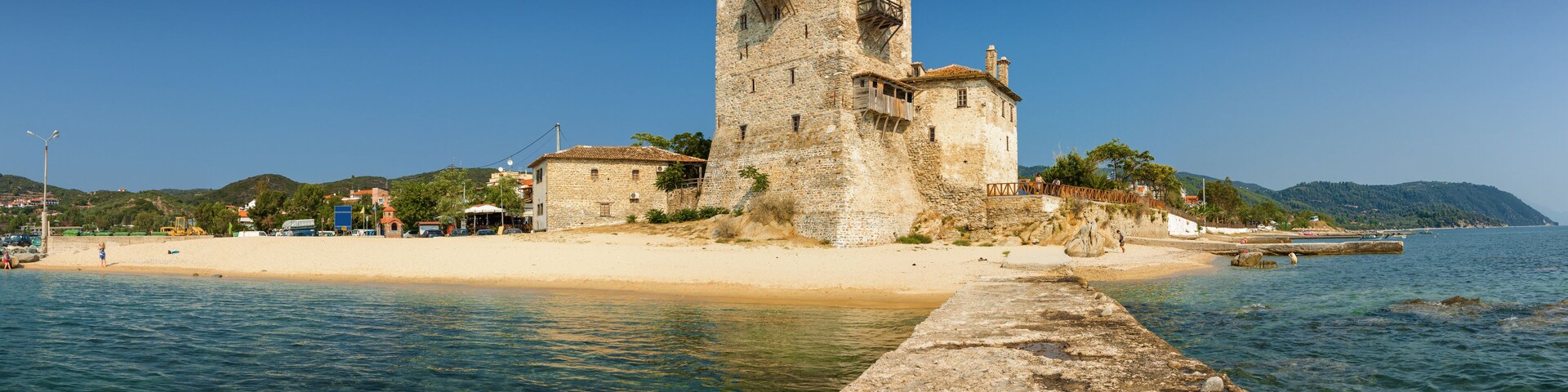 Sunny panoramic view of tower in Uranopolis bay, Greece.