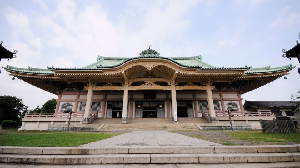 A traditional building with a green roof and ornate architecture.