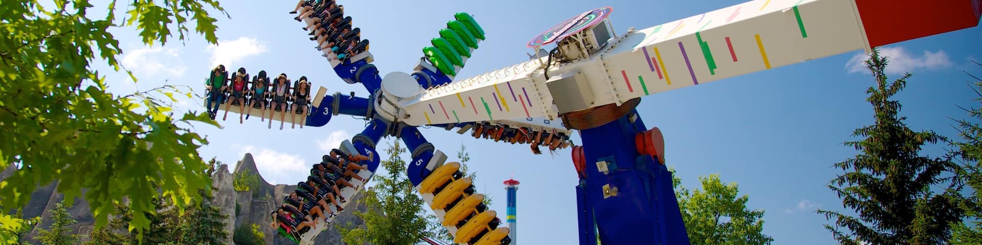 A large amusement park ride with multiple seats and a blue and white structure.