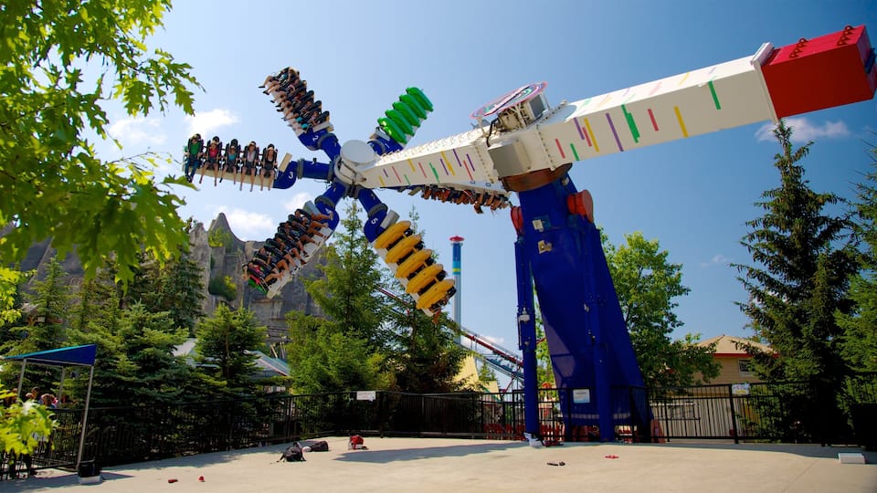 A large amusement park ride with multiple seats and a blue and white structure.
