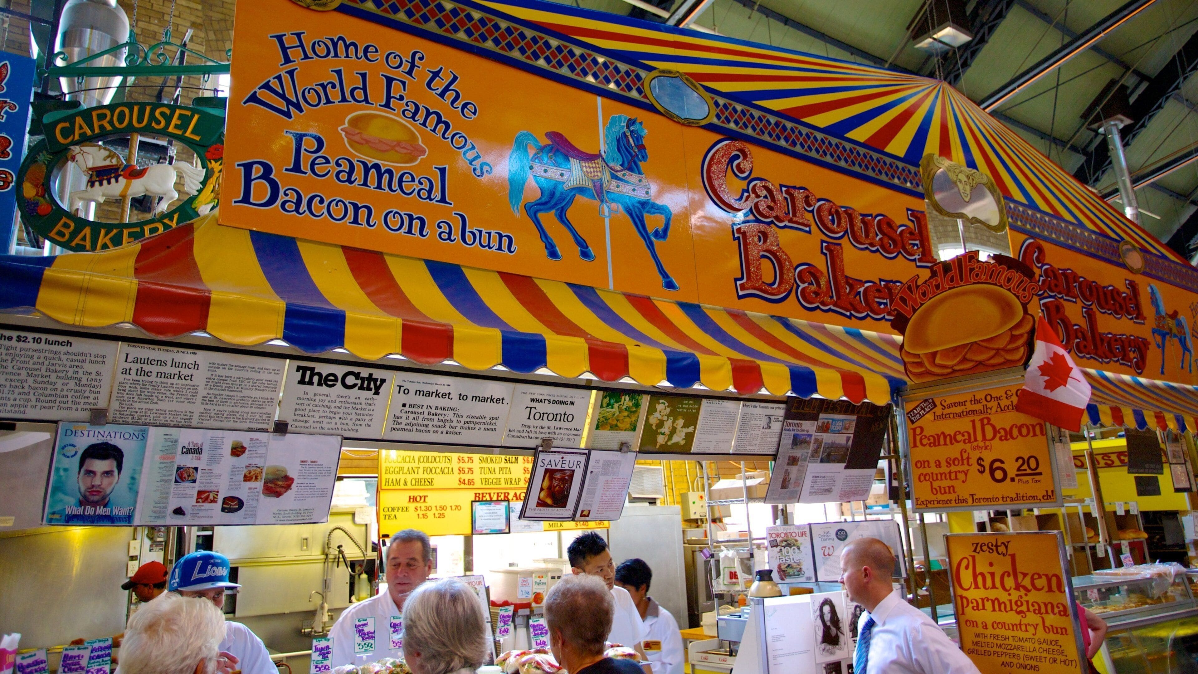 A colorful carousel bakery with a peameal bacon on a bun sign.