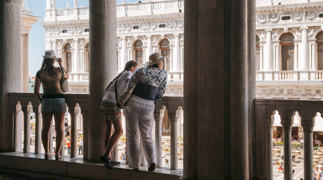 Doge\'s Palace featuring views as well as a small group of people