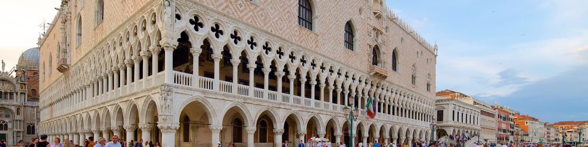 St. Mark\'s Square which includes a square or plaza and heritage architecture as well as a large group of people