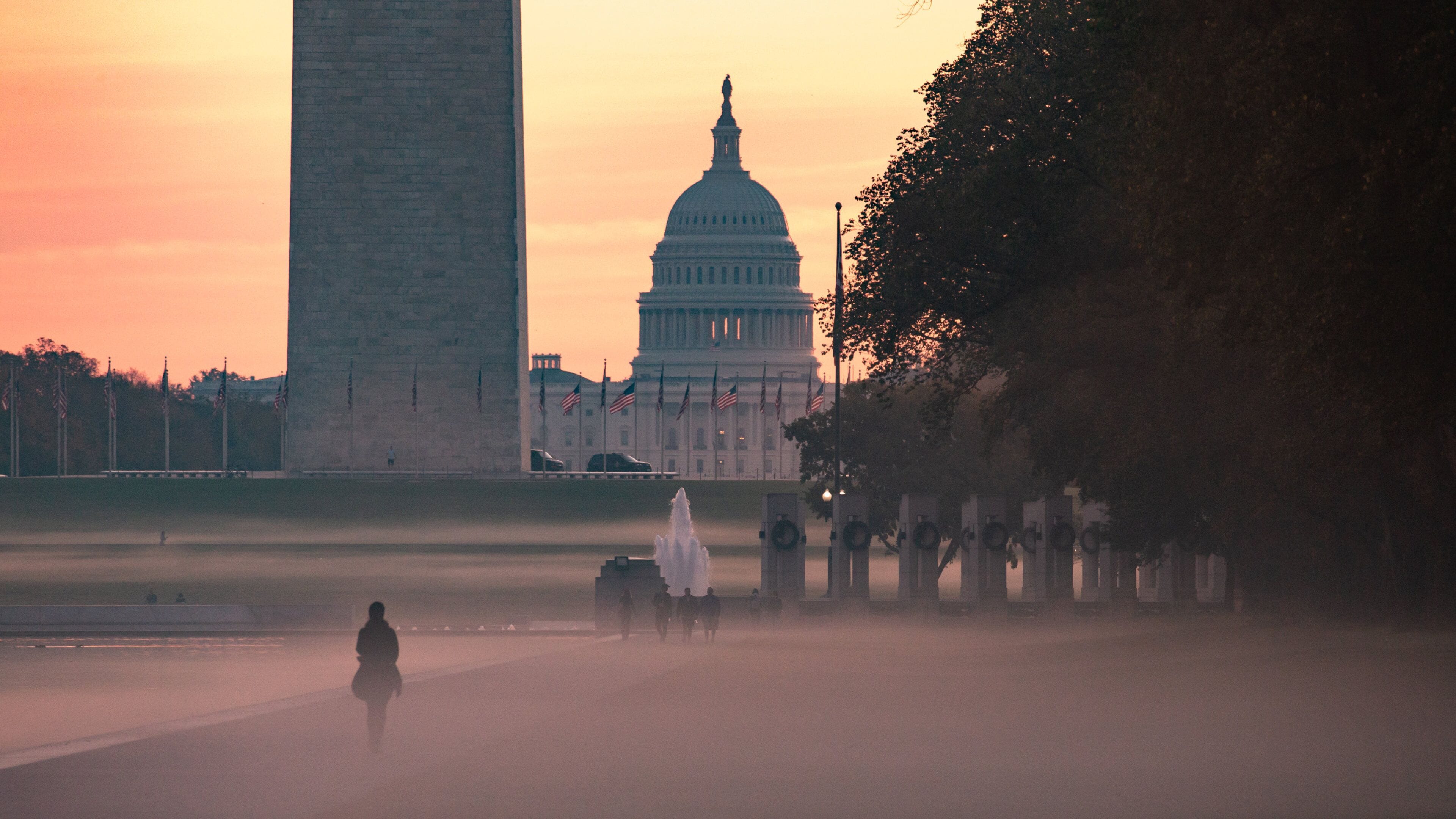 United States Capitol featuring a sunset, mist or fog and heritage architecture