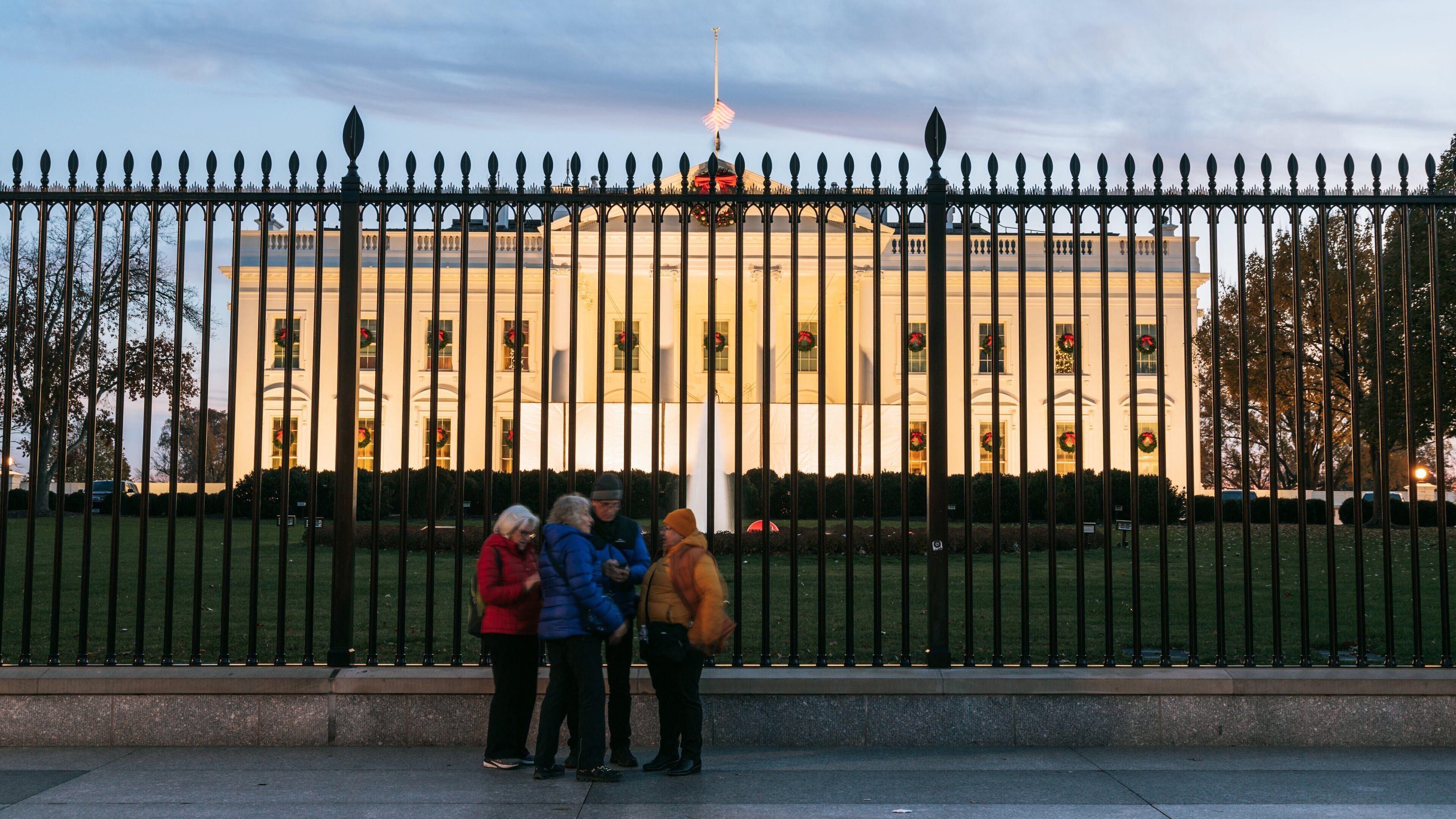 White House showing an administrative buidling and heritage architecture as well as a small group of people