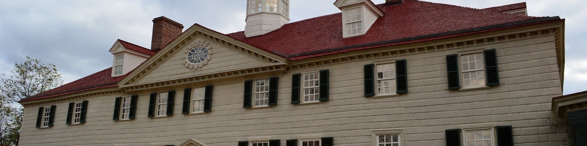 Mount Vernon was the plantation house of George Washington, first President of the United States and his wife, Martha Dandridge Custis Washington. The estate is situated on the banks of the Potomac River in Fairfax County, Virginia, near Alexandria, across from Prince George's County, Maryland. The Washington family had owned land in the area since the time of Washington's great-grandfather in 1674. In 1739 they embarked on an expansion of the estate that continued under George Washington, who came into possession of the estate in 1754, but did not become its sole owner until 1761.
The mansion is built of wood in a loose Palladian style, and was constructed by George Washington in stages between 1758 and 1778. It occupies the site of an earlier, smaller house built by George Washington's father Augustine, some time between 1726 and 1735. It remained Washington's country home for the rest of his life. Following his death in 1799, under the ownership of several successive generations of the family, the estate progressively declined as revenues were insufficient to maintain it adequately. In 1858, the house's historical importance was recognized and it was saved from ruin by The Mount Vernon Ladies' Association; this philanthropic organization acquired it together with part of the Washington property estate. Escaping the damage suffered by many plantation houses during the American Civil War, Mount Vernon was restored.
Mount Vernon was designated a National Historic Landmark in 1960 and is today listed on the National Register of Historic Places. It is still owned and maintained in trust by The Mount Vernon Ladies' Association, and is open every day of the year. Allowing the public to see the estate is not an innovation, but part of a 200-year-old tradition started by George Washington himself. In 1794 he wrote: "I have no objection to any sober or orderly person's gratifying their curiosity in viewing the buildings, Gardens, &ca. about Mount Verno