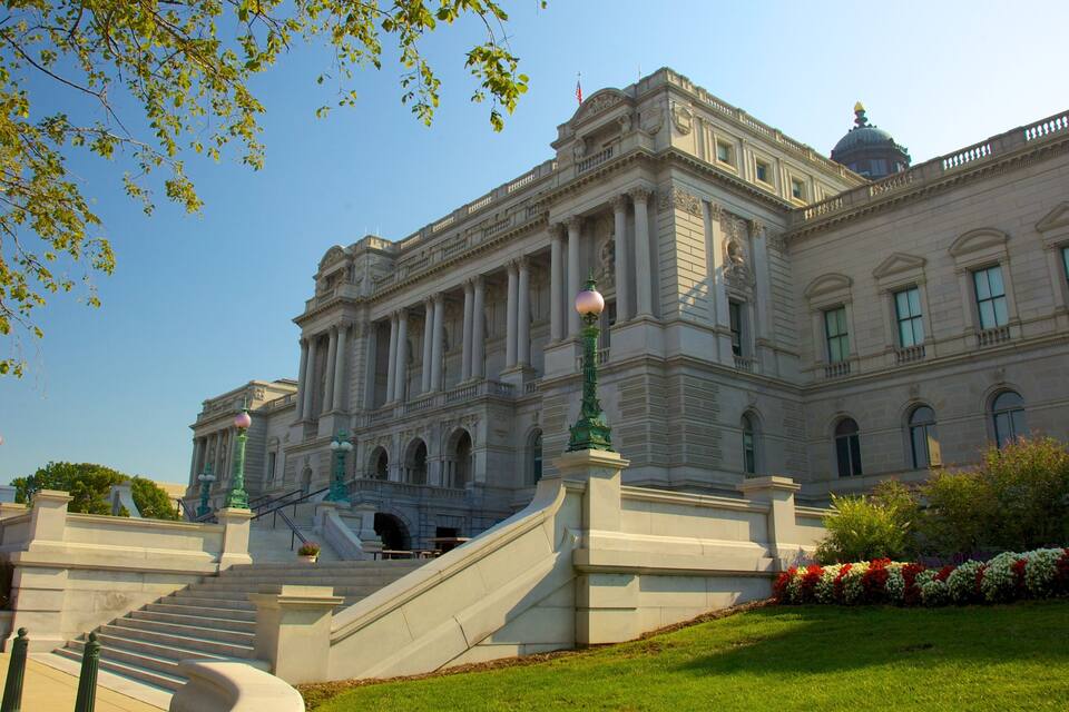A grand building with classical architecture, featuring columns, a dome, and a staircase leading to the entrance.