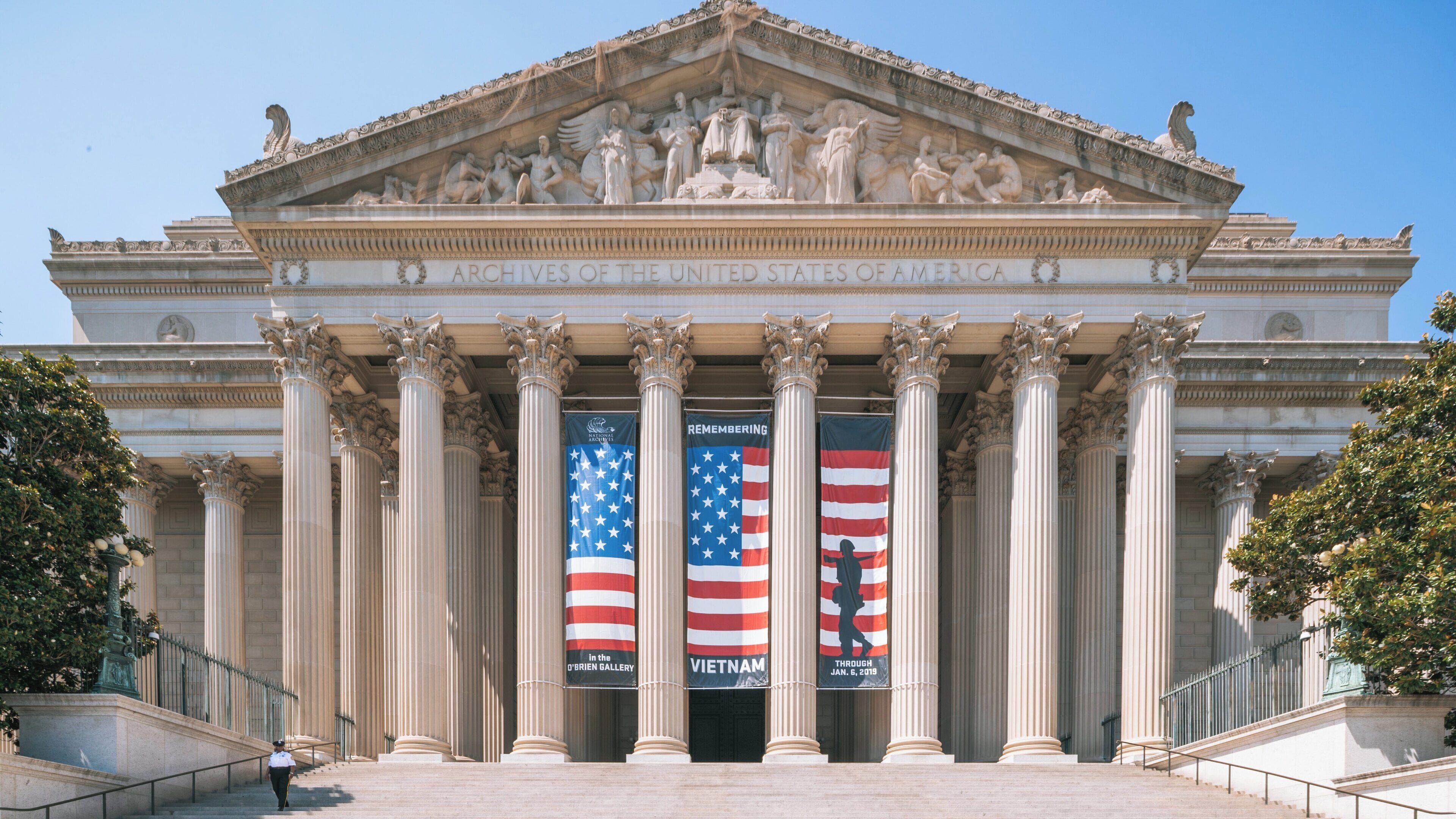 National Archives building in downtown Washington D.C. displaying flags and banners celebrating American history and culture