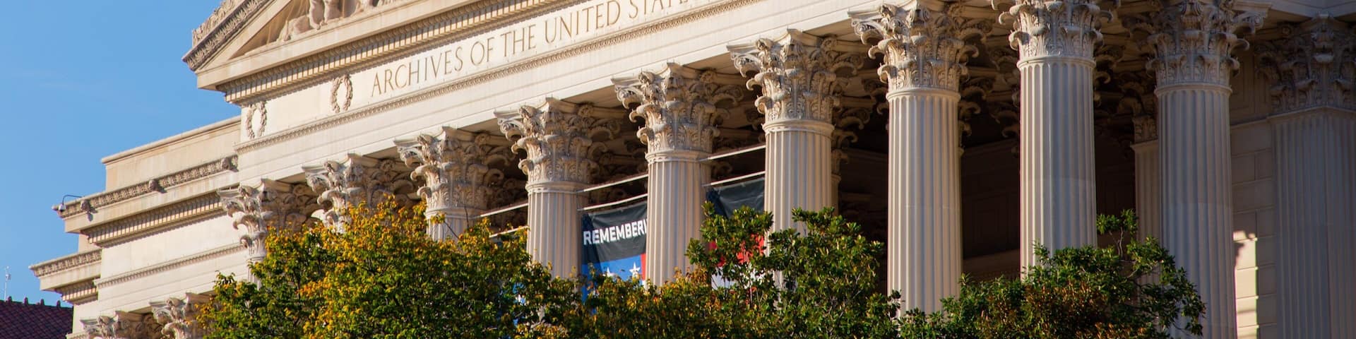 The United States Capitol building with classical architecture, including columns and detailed sculptures.