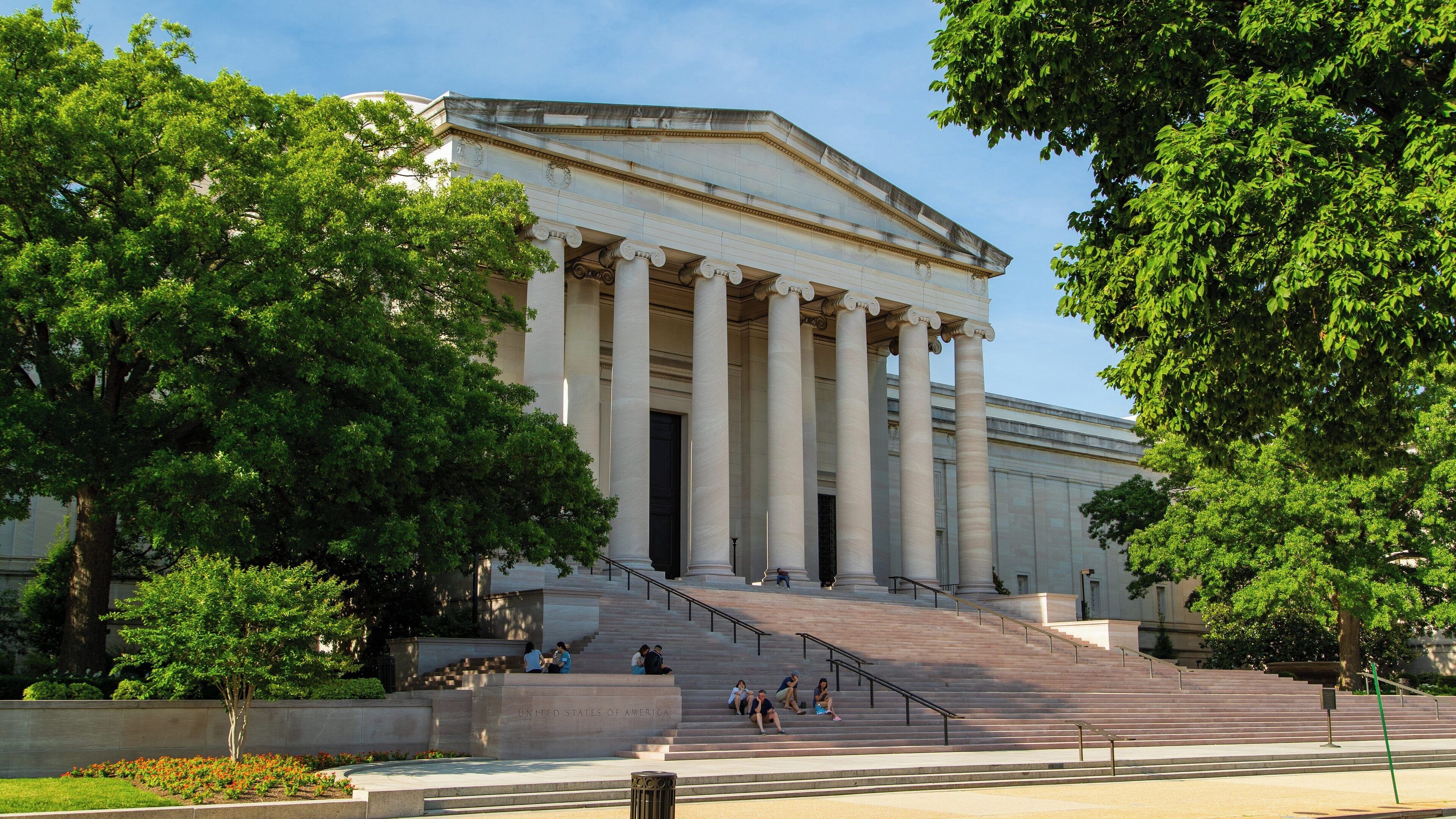National Gallery of Art showcases classic architecture and vibrant greenery in downtown Washington D.C. during a sunny day