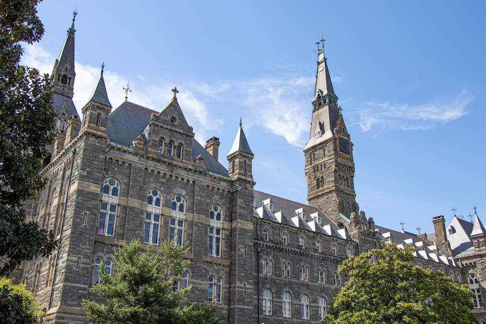 A historic building with multiple towers and arched windows.