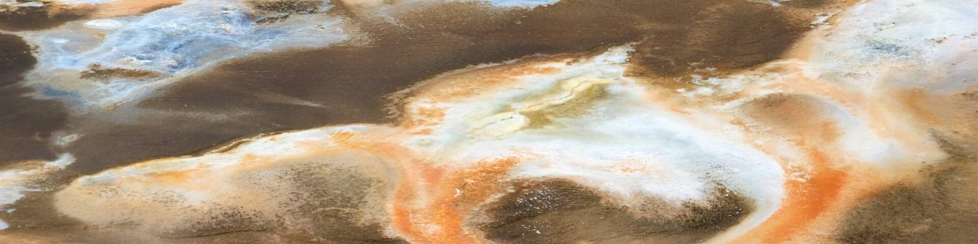 A close-up of a mineral deposit with various colors and textures.