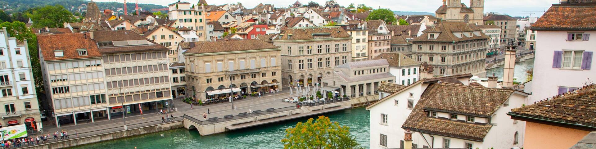 A river with buildings and a bridge in a European city.