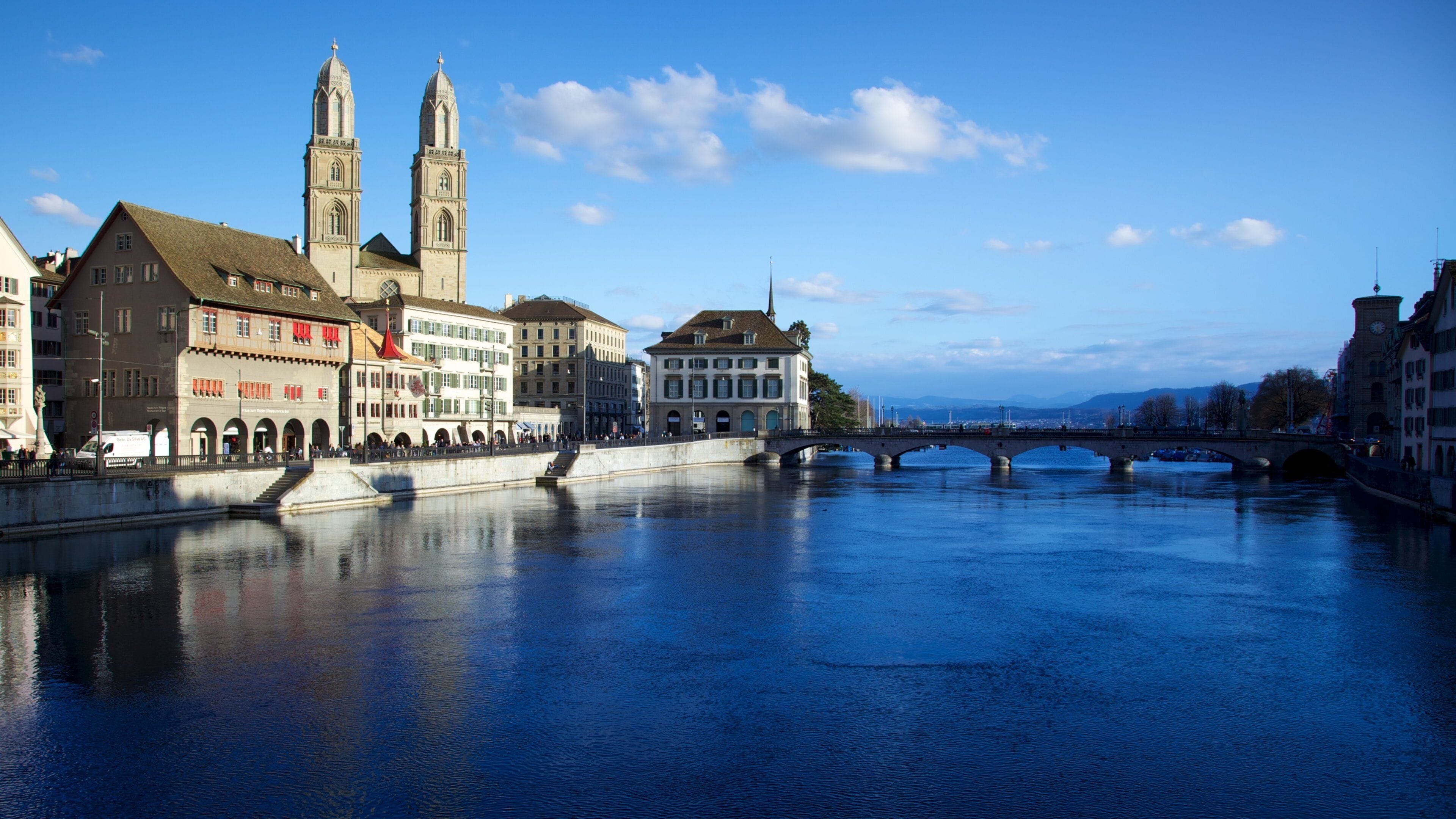 Grossmuenster which includes religious elements, a river or creek and a bridge