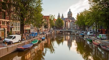 Red Light District showing a city, a river or creek and a sunset