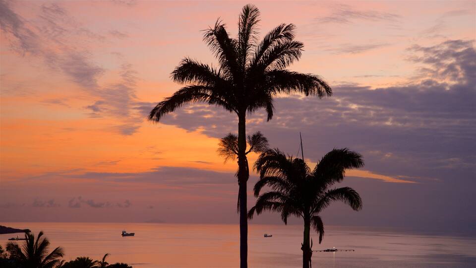 Dickenson Bay Beach featuring tropical scenes, a sunset and a sandy beach