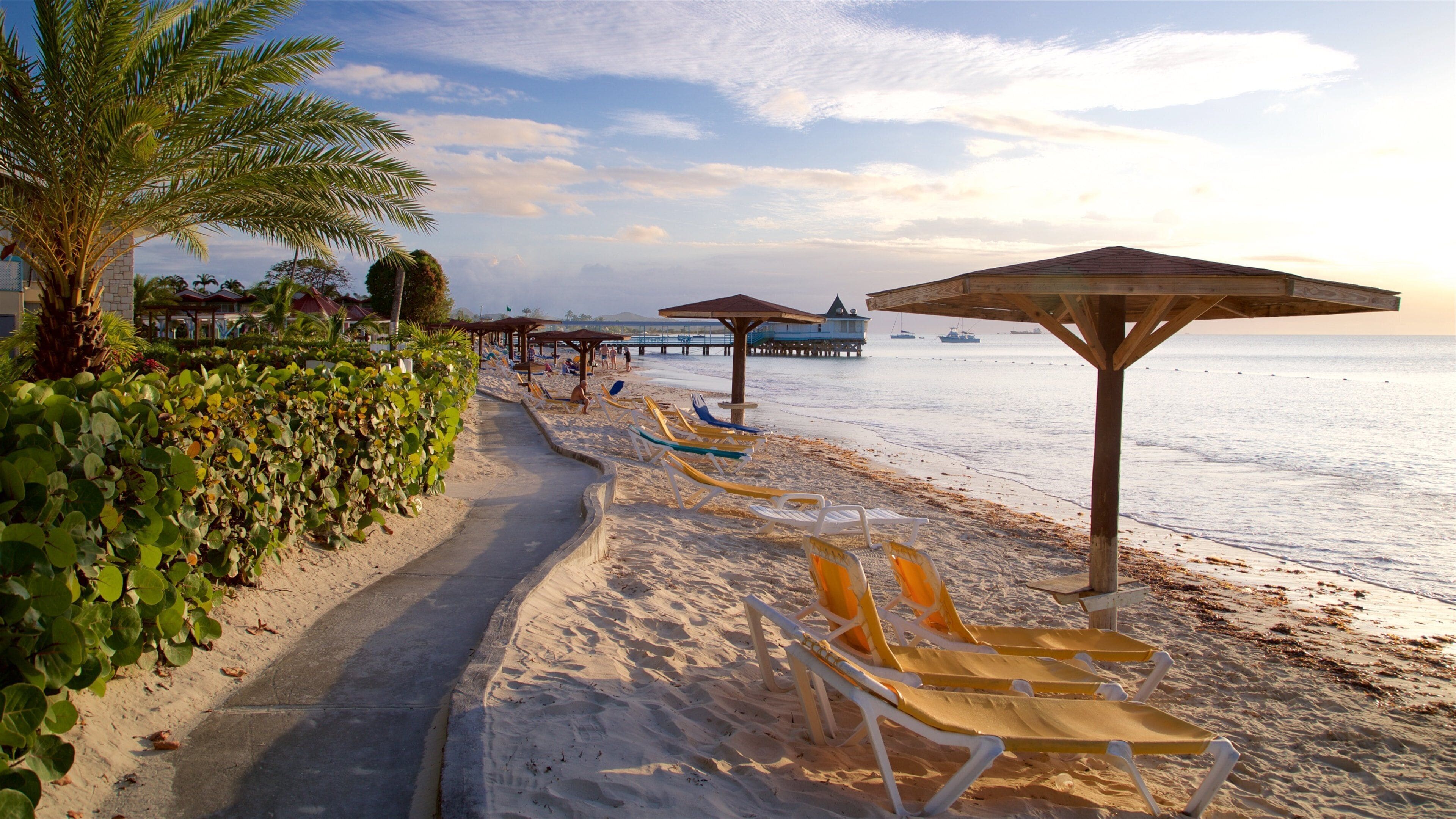 Dickenson Bay Beach which includes a sunset, tropical scenes and a beach