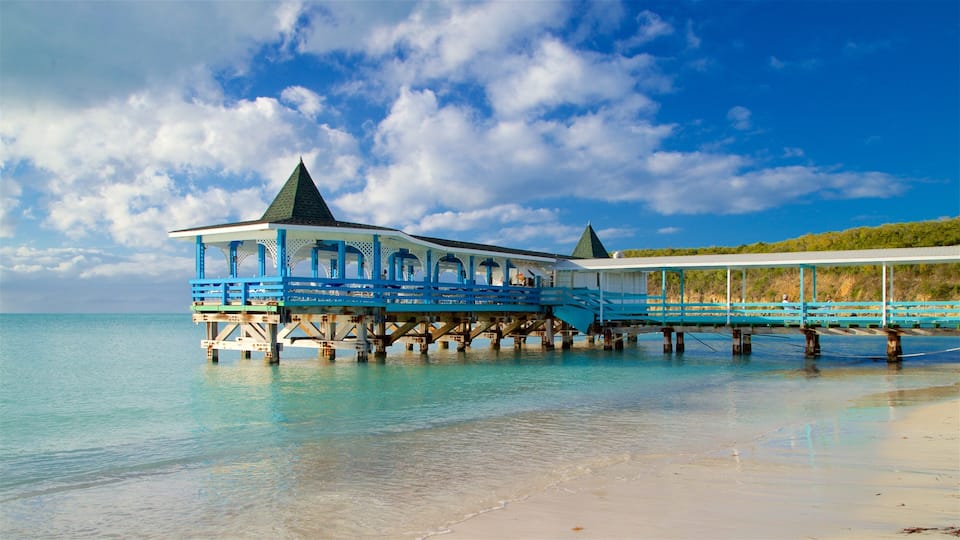Dickenson Bay Beach showing rugged coastline, general coastal views and a beach