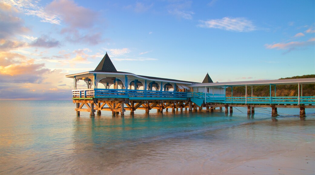 Dickenson Bay Beach featuring a sandy beach, a sunset and general coastal views