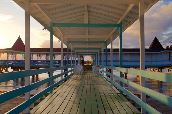 Dickenson Bay Beach showing a sunset, a beach and general coastal views