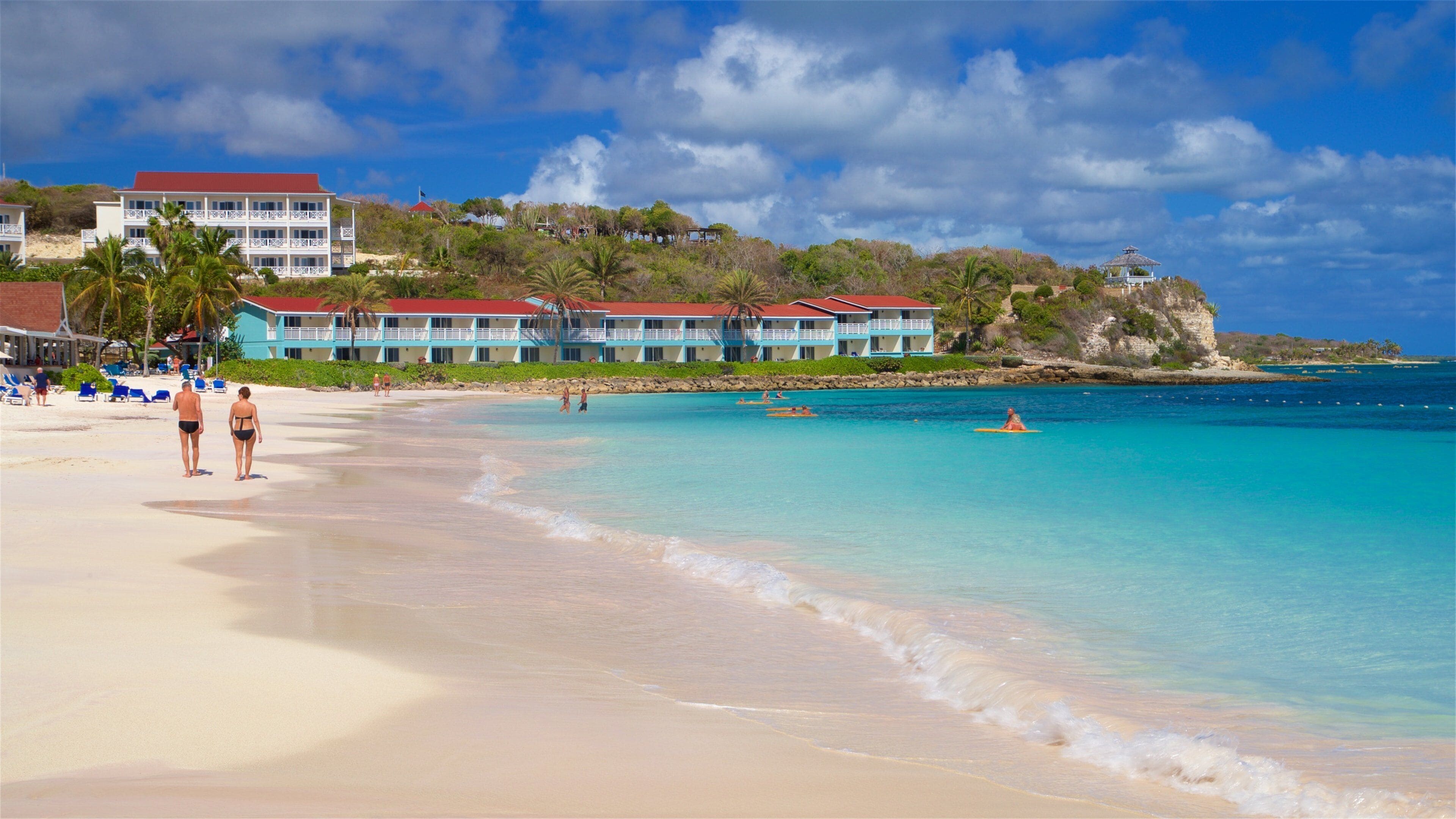 Long Bay showing a beach, a coastal town and general coastal views