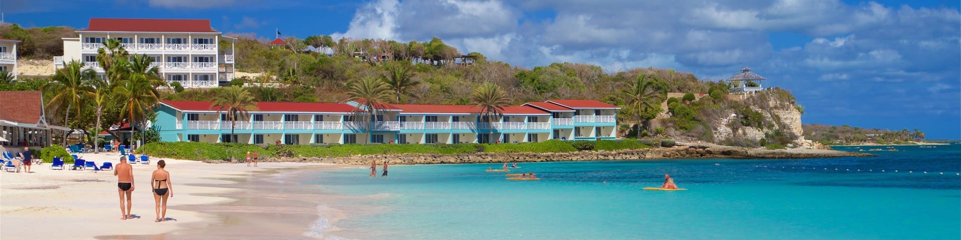 Long Bay showing a beach, a coastal town and general coastal views
