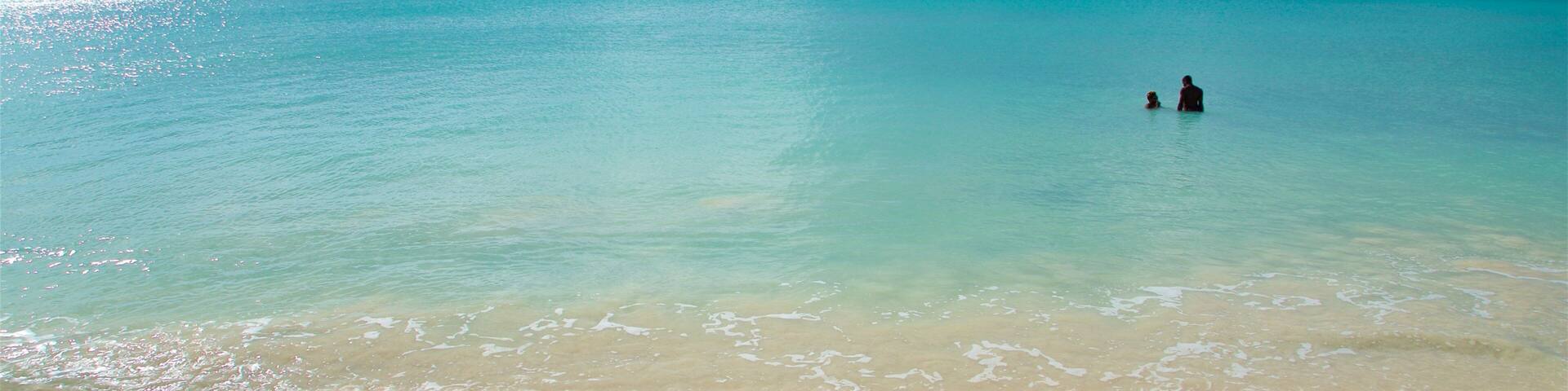 Runaway Bay Beach showing general coastal views, a sandy beach and swimming