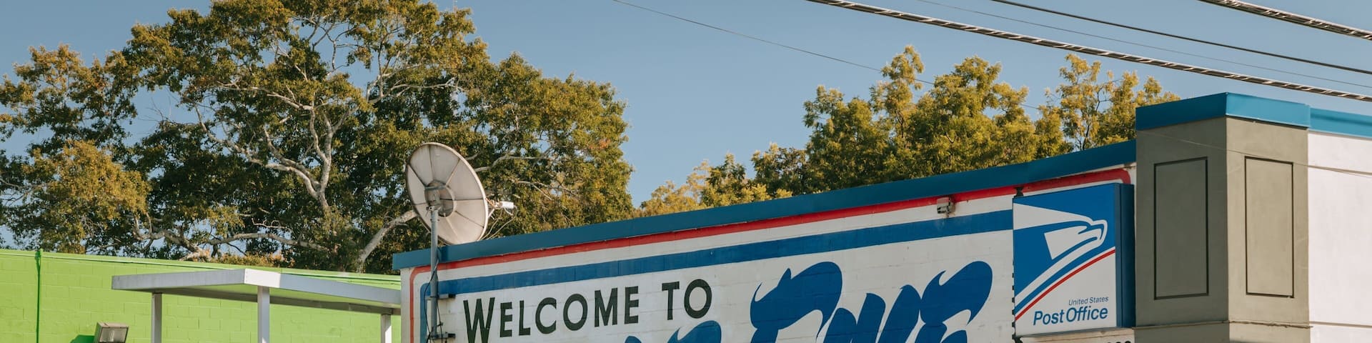 A mural with the text "Welcome to Little Fine Points" and a mailbox.