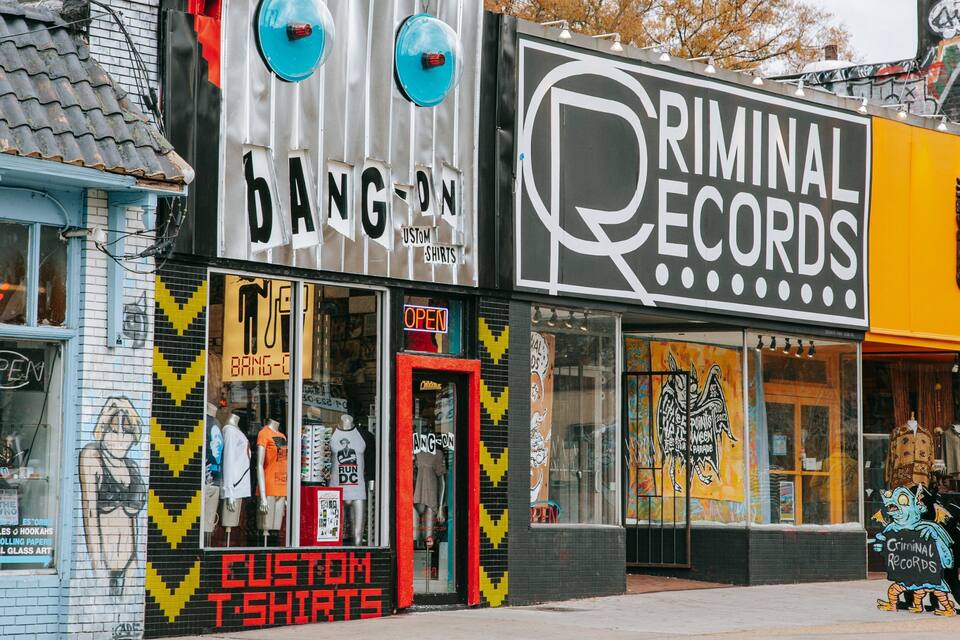 Storefronts with signs for 'Bang-On' and 'Criminal Records'.