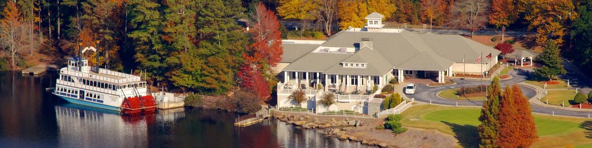 Scenic view of Stone Mountain Park in Georgia with autumn foliage and a paddle boat on the lake