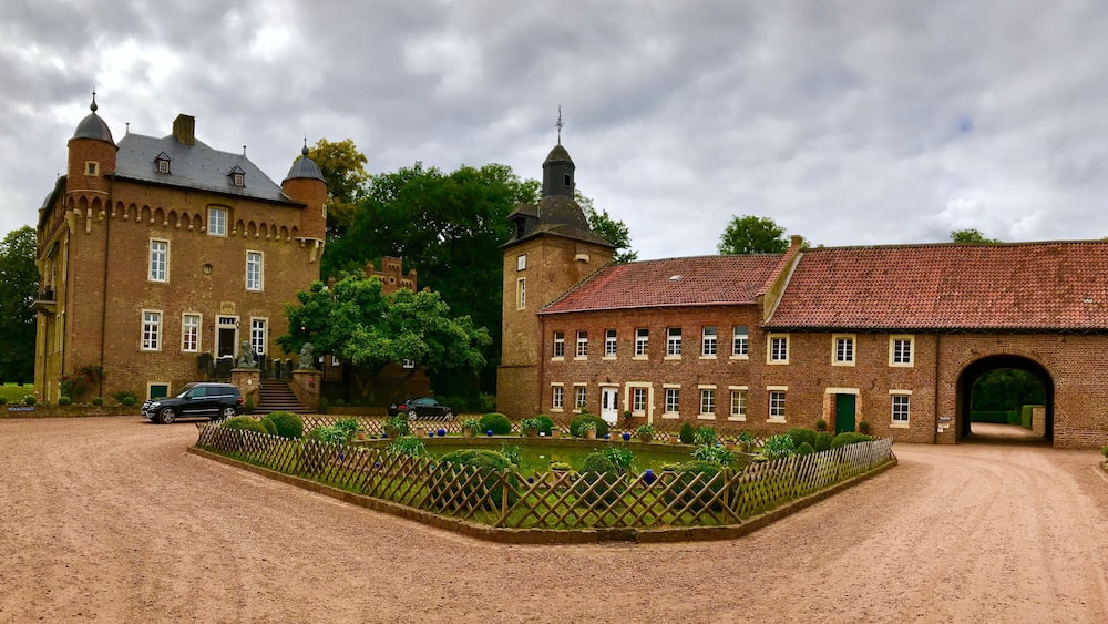 Ein historisches Backsteingebäude mit einem Turm und einem großen Bogen.