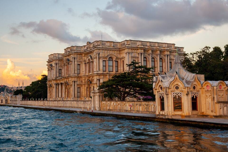 A historic building with ornate architecture by the waterfront.