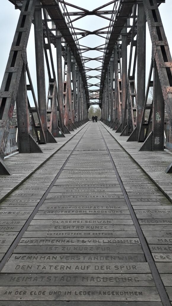 A bridge with engraved names and a metal framework.